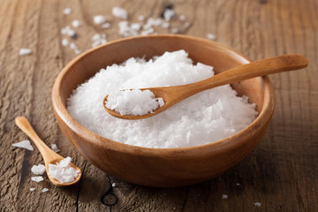 Fototapeta na wymiar sea salt in wooden bowl and spoon