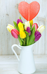 colorful tulips on wooden table