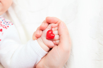 hands of mother and baby closeup holding heart © nadezhda1906