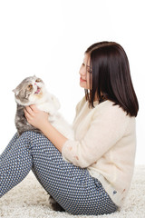 Fototapeta premium Portrait of a beautiful young woman and a large cat,on white