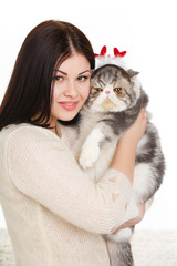 Portrait of a beautiful young woman and a large cat,on white
