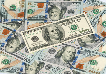 hundred dollar bills in a pile