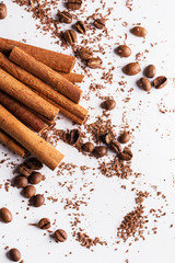 Cinnamon sticks, coffe beans and particles of chocolate