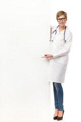 Female doctor pointing at a banner.