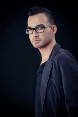 Obraz premium fashion portrait of the young beautiful man - dark background