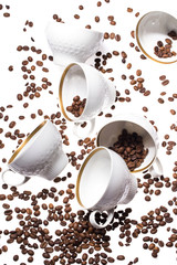Obraz na płótnie Canvas Falling coffee cups and beans