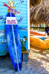 Surfboards based on the hut to rent boards on Dominican  beach - obrazy, fototapety, plakaty