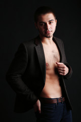 Obraz premium Handsome young man on dark background