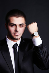 Naklejka premium Handsome young man in suit on dark background