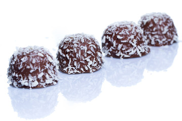 Chocolate candies with coconut flakes