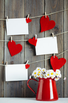 Photos and hearts on wooden wall
