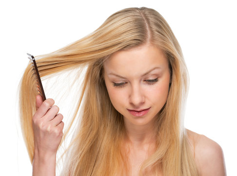 Young woman combing hair