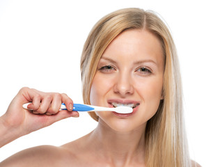 Portrait of happy young woman brushing teeth