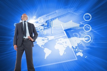 Composite image of happy businessman with hand on hip