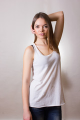 Obraz premium Portrait of a beautiful young woman in a white T-shirt