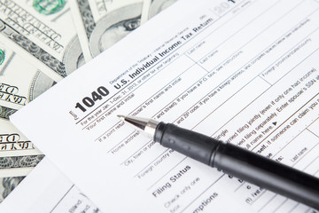 Tax forms with dollar bills
