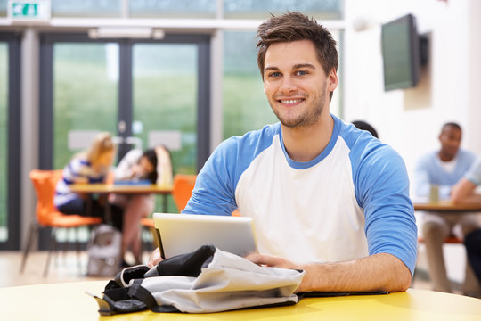 Male Student Studying In Classroom With Digital Tablet