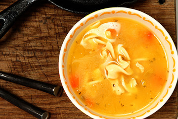 Chicken Noodle Soup on Wooden Table in Bowl