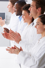 Fototapeta na wymiar Technician And Colleagues In Laboratory Clapping