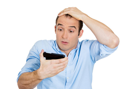 Shocked man holding phone, receiving  bad news