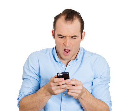 Surprised man with phone, texting, receiving bad news