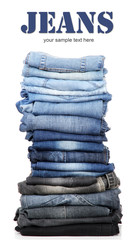 Many jeans stacked in a pile isolated on white