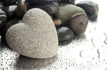 Grey stone in shape of heart, on light background