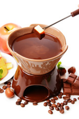 Chocolate fondue with fruits, isolated on white