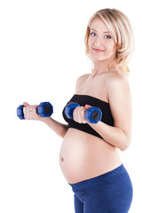 A pregnant woman exercising with a light weights - isolated