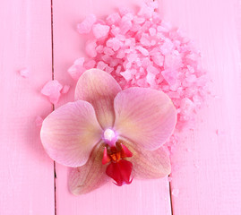 Beautiful blooming orchid flower  and heap of sea salt,