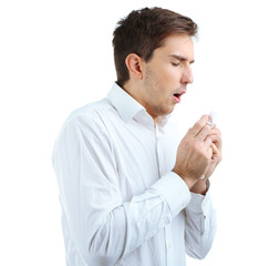 Sneezing young man isolated on white