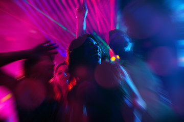 Party people dancing in disco or night club - obrazy, fototapety, plakaty