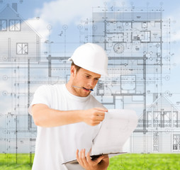 male architect looking at blueprint