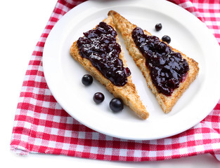 Delicious toast with jam on plate close-up