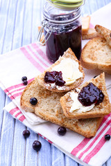 Delicious toast with jam on table close-up