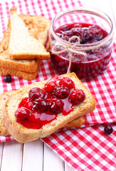 Delicious toast with jam on table close-up