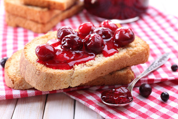 Delicious toast with jam on table close-up