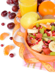 Sweet fresh fruits in bowl on table close-up
