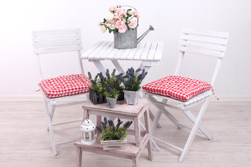 Garden chairs and table with flowers