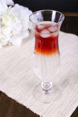 Glass of cocktail on table close-up