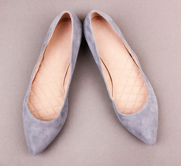 Beautiful female shoes, on grey background
