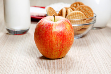 An apple and cookies on table