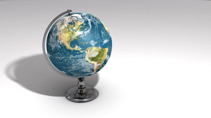 A realistic globe on a chrome pedestal over white A