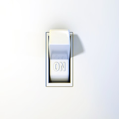 Close up of a wall light switch in the on position