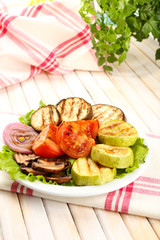 Delicious grilled vegetables on plate on table close-up