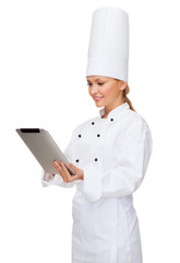 smiling female chef with tablet pc computer