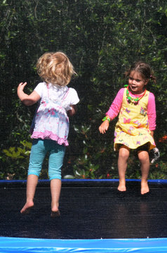 Happy children jumping on trampoline
