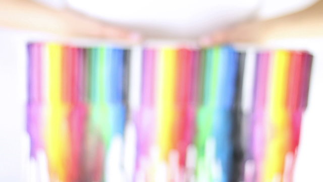 Hands showing melted crayons colorful painting