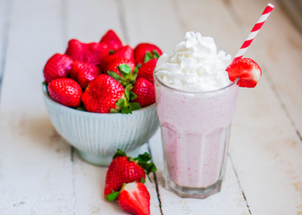 Strawberry milkshake on wooden background