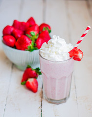 Strawberry milkshake on wooden background